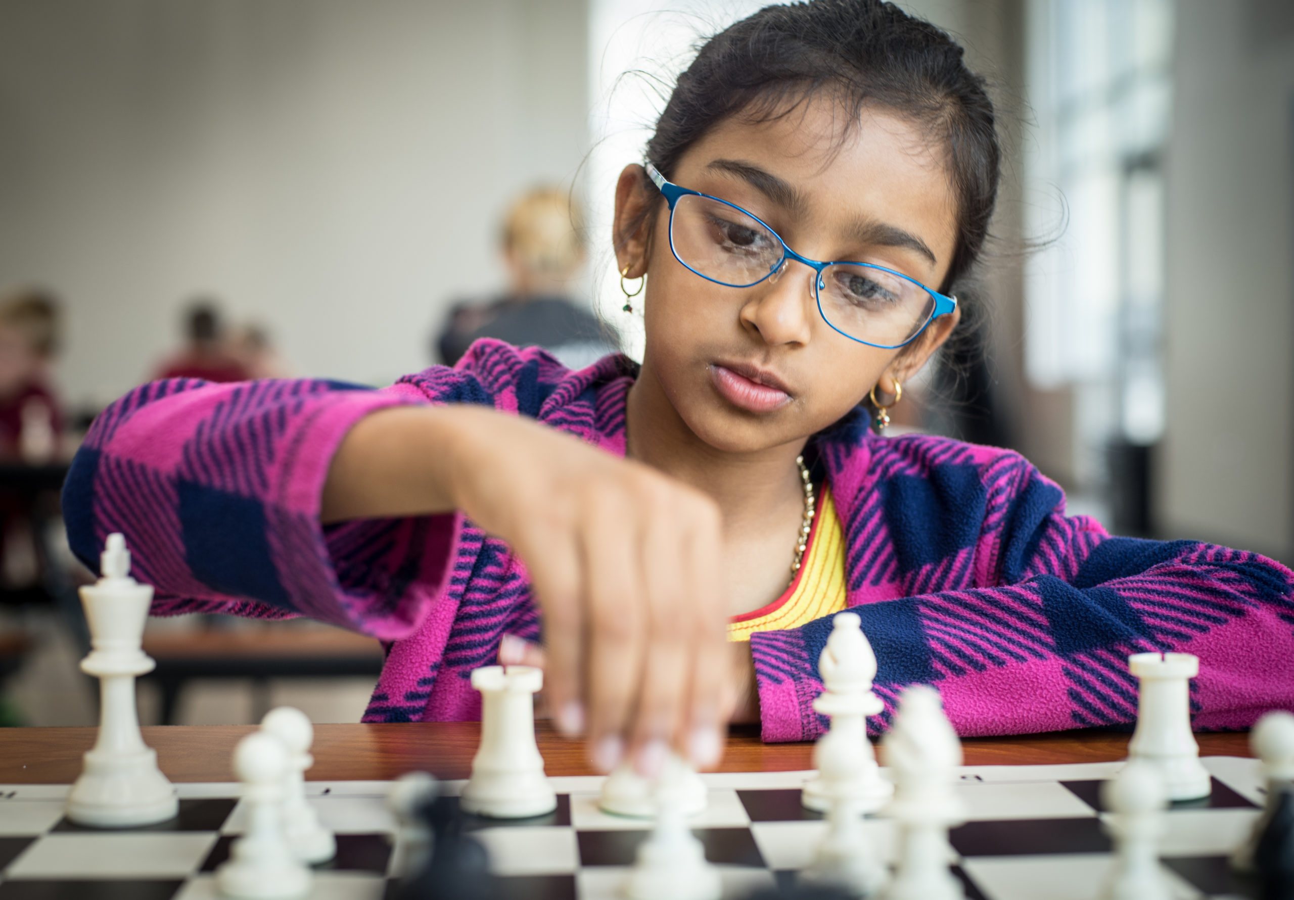 Girl plays chess at chess camp